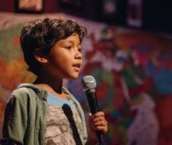Boy speaking into microphone